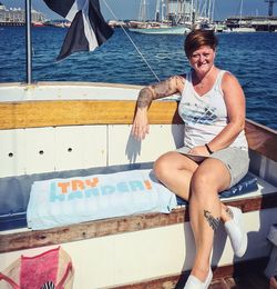 Full length of woman sitting on boat against sea