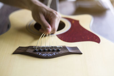 Close-up of hand playing guitar