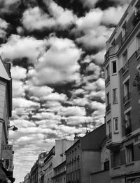 Low angle view of building against cloudy sky