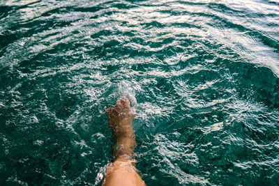 Low section of person in swimming pool