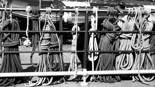 Ropes tied on metallic railing during sunny day