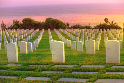 Panoramic view of cemetery against sky at sunset
