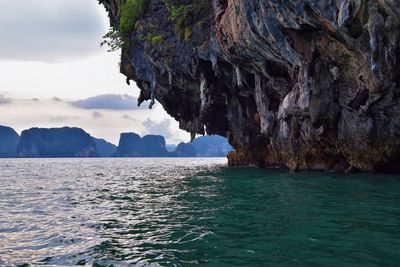 Scenic view of rock formation in sea against sky