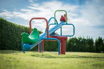 Boy on grass against sky