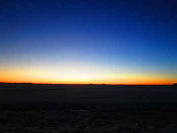 Scenic view of silhouette landscape against clear sky during sunset