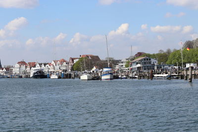 View of townscape by sea against sky