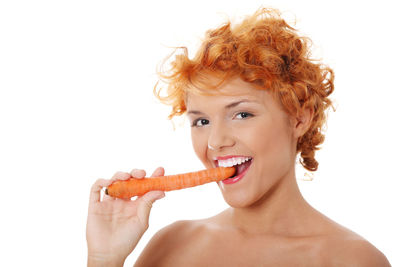 Portrait of a smiling young woman eating food