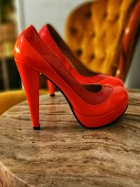 Close-up of red shoes on table