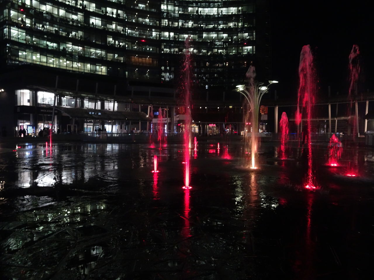 DIGITAL COMPOSITE IMAGE OF ILLUMINATED PEOPLE AT NIGHT