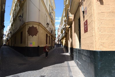 Street amidst buildings against clear sky