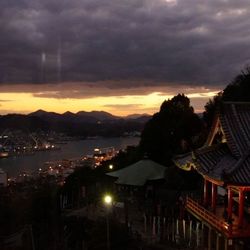 Town against cloudy sky at dusk