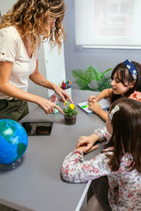 High angle view of mother playing with daughter at home