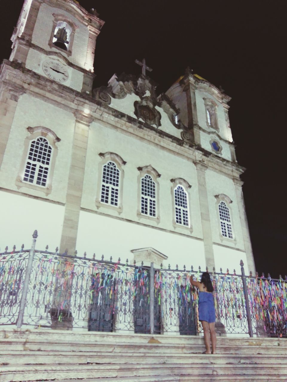 architecture, building exterior, built structure, place of worship, religion, spirituality, church, low angle view, facade, person, history, night, outdoors, men, sky, entrance, lifestyles