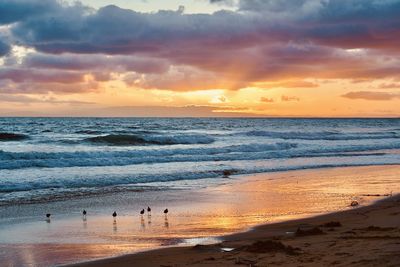 Scenic view of beach against sky during sunset