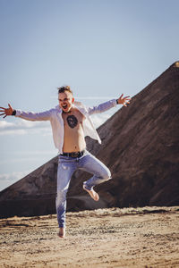 Full length portrait of a man jumping