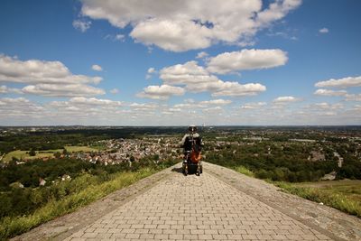 Rear view of mature man looking at view while sitting on wheelchair