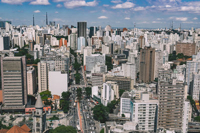 High angle view of cityscape against cloudy sky