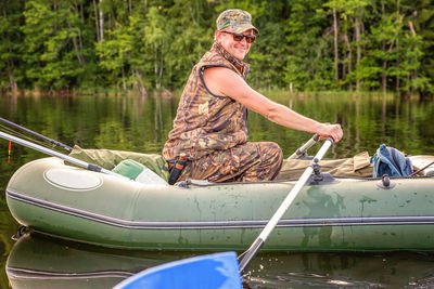 Rear view of man kayaking in lake