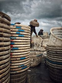 Workers emptying fish from baskets
