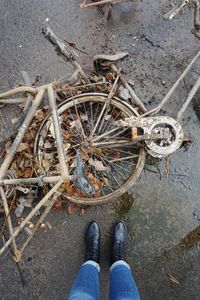 Low section of person standing on bicycle