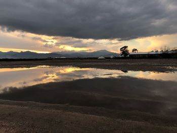 Scenic view of beach against sky during sunset