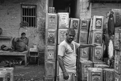 Rear view of man sitting on old building