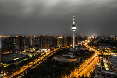 High angle view of city lit up at night