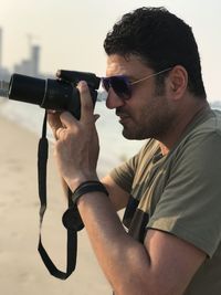 Side view of a man photographing