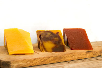 Close-up of bread on cutting board against white background