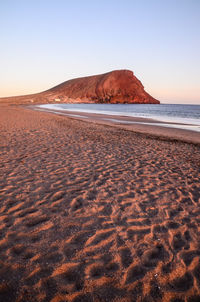 Scenic view of beach against clear sky