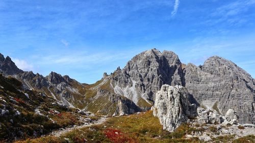 Rocks on mountain against blue sky