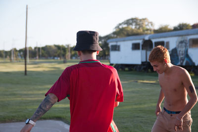 Rear view of men playing on field