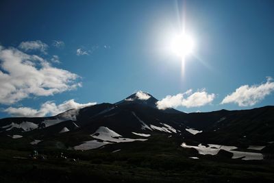 Scenic view of snowcapped mountains during sunny day