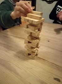 Rear view of man playing on wooden table