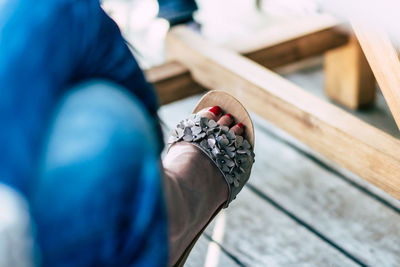 Low section of woman wearing sandal