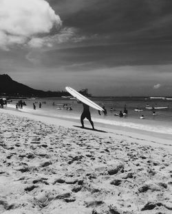 People on beach against sky