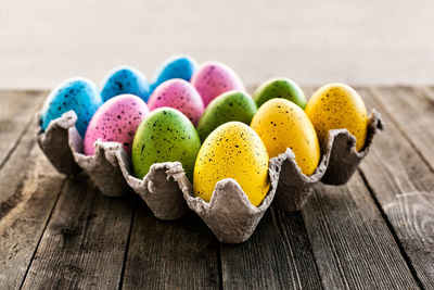 Close-up of multi colored candies on wooden table