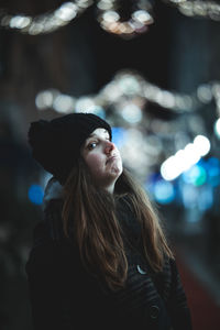 Portrait of young woman standing outdoors