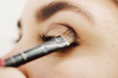 Close-up of woman applying eyeshadow