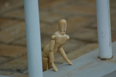 Close-up of stuffed toy on metal structure