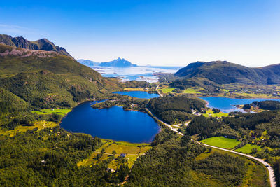 Scenic view of lake and mountains against blue sky