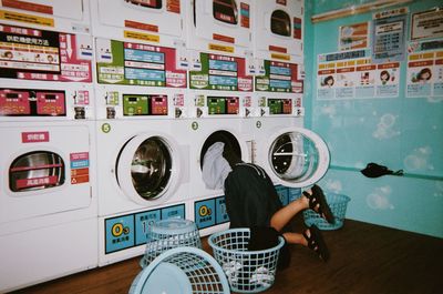 Low section of woman inside washing machine