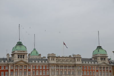Buildings in city against sky