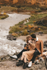 Couple sitting on rock