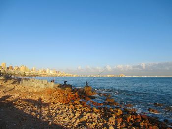 Scenic view of sea against clear blue sky