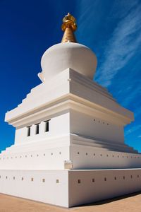 Low angle view of white building against blue sky