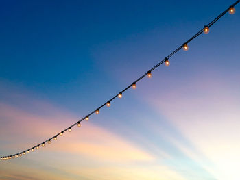 Low angle view of barbed wire against sky