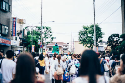 Group of people walking in front of buildings