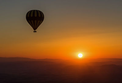 Hot air balloon flying in sky during sunset