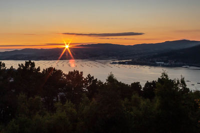 Scenic view of silhouette mountains against sky during sunset